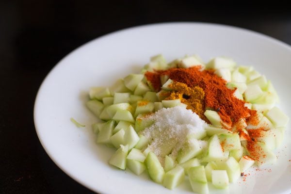spices, salt added to chopped mango cubes.