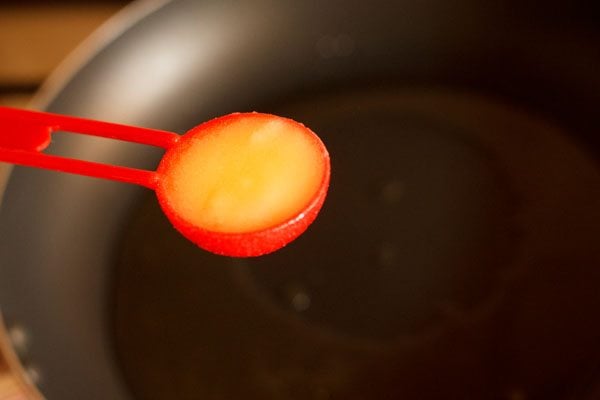 adding ghee in a hot pan for making sweet vermicelli. 