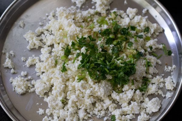 finely chopped ginger, finely chopped green chili and finely chopped coriander or parsley added to the crumbled paneer. 