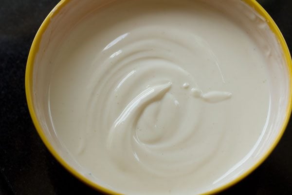 smooth whipped yogurt in a yellow bowl