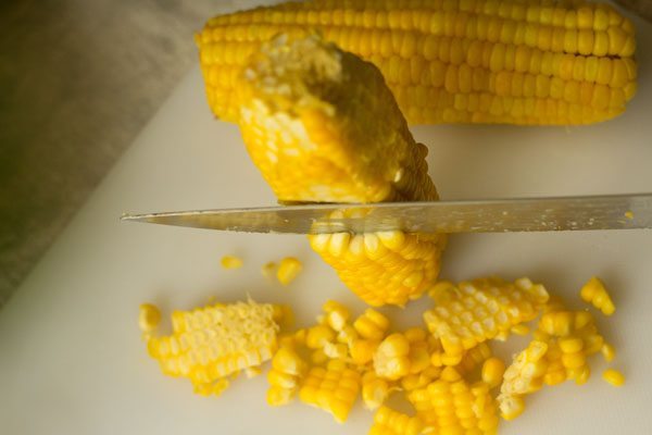 scraping corn kernels
