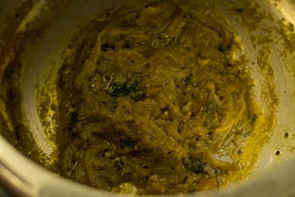 mixing turmeric powder with masala