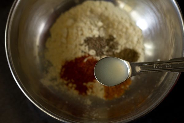 adding lemon juice to the spiced gram flour. 