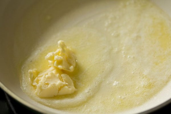 butter added in a pan for making butter mushroom. 