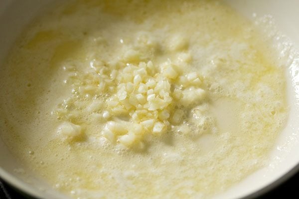 chopped garlic added to melted butter in pan. 