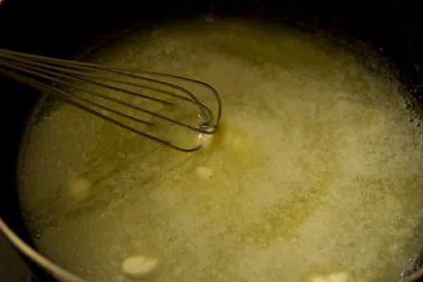 stirring the melting butter in the pan. 