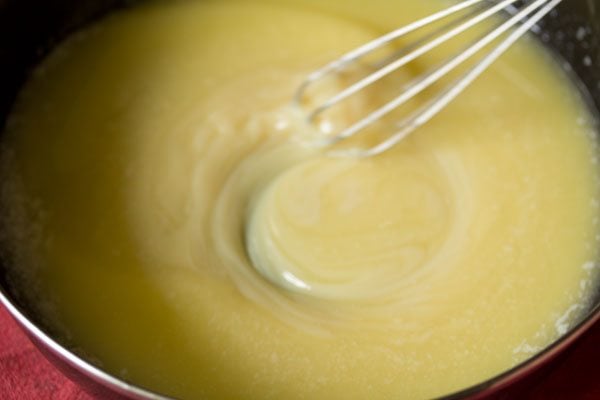 whisking the melted butter-condensed milk mixture in the pan. 