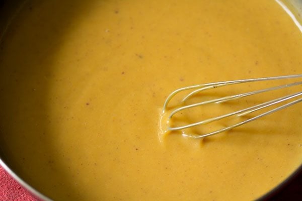 mixing mango-condensed milk mixture in the pan. 