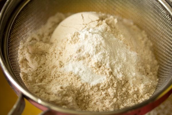 whole wheat flour, baking powder, baking soda and salt in a sieve. 