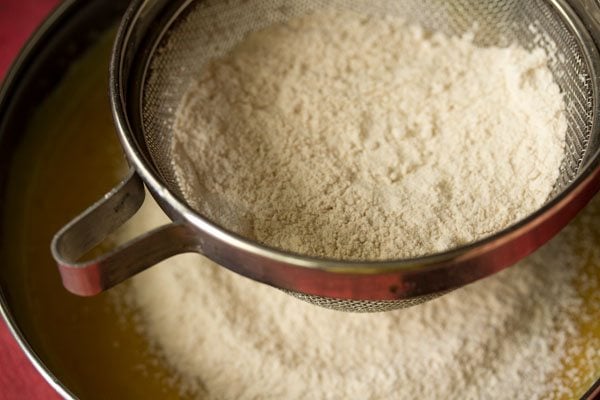 dry ingredients sieved directly into the mango mixture in the pan. 