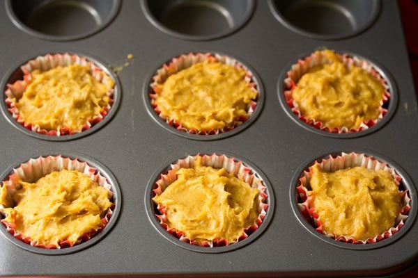 batter spooned in muffin liners filling 3/4th of the liners. 