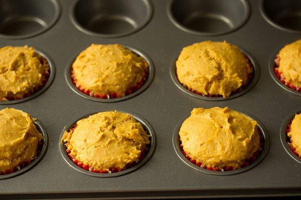 baking mango muffins in the preheated oven. 