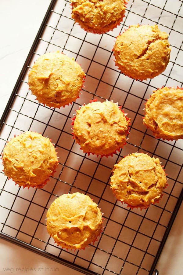 mango muffins placed on a wired tray. 
