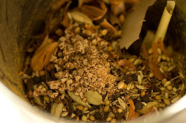 crushed nutmeg added on the whole spices in the grinder.