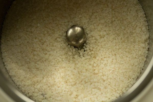 grinding the rice grains to a semi-fine consistency. 