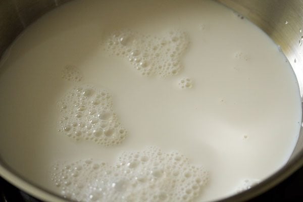 heating full fat milk in a pan. 