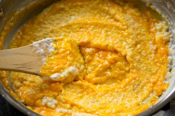 mixing mango puree in the phirni mixture. 