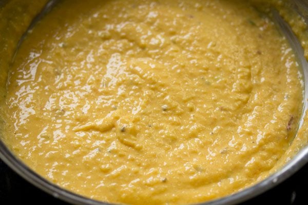 mixing mango puree in the phirni mixture. 