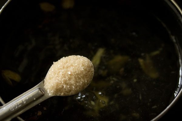 Raw sugar being added with a teaspoon