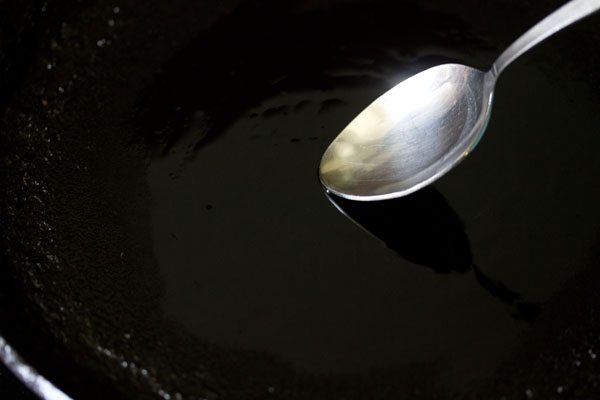 spreading oil on hot cast iron pan. 