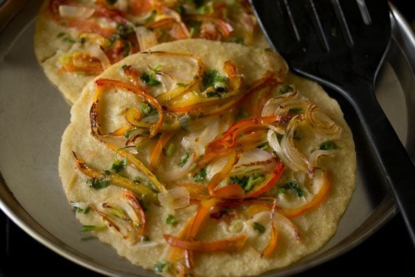 cooked oats uttapam on a plate. 