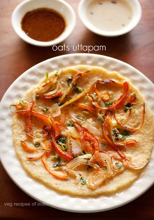 oats uttapam served on a white plate with bowls of chutney kept in the background and text layover.