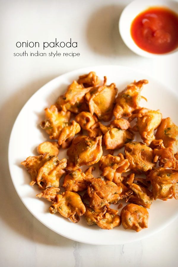 onion pakoda recipe served on a white plate with chutney 