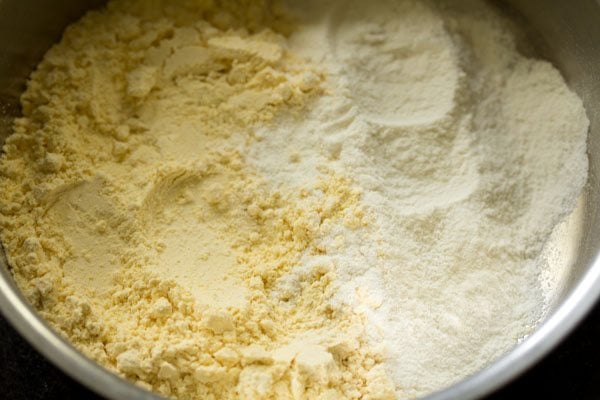 gram flour and rice flour added in a mixing bowl for making onion fritters. 