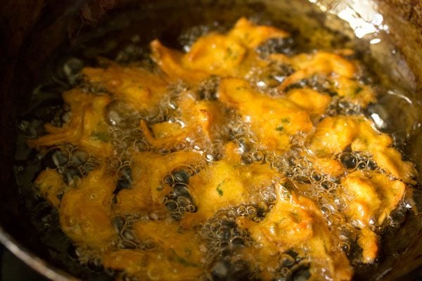 frying onion fritters till golden and crisp in hot oil. 