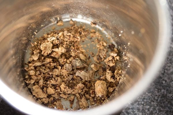 crushing nutmeg in a mortar pestle. 