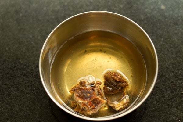 soaking tamarind in warm water for making pepper rasam. 