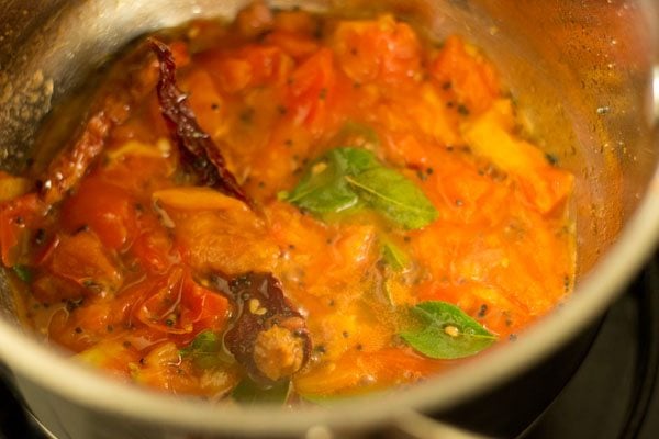 sautéing tomatoes for making pepper rasam. 