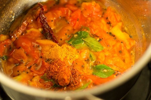 turmeric powder and red chili powder added to the pan. 