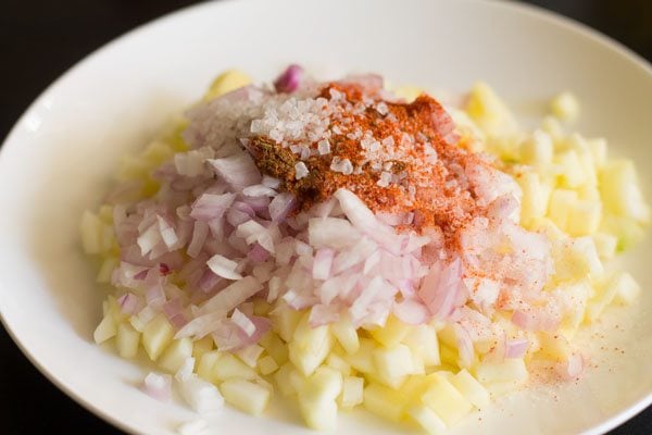 red chili powder, roasted cumin powder, sugar and salt added to the mango-onion mixture. 