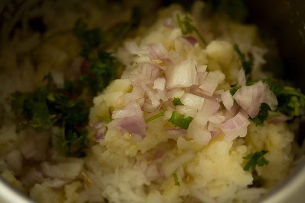 chopped onion, chopped green chili and chopped coriander leaves added to the rice-potato mixture. 
