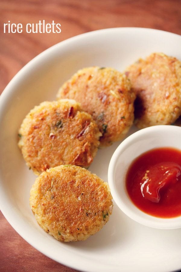 rice cutlet served on a white plate with a small bowl of tomato ketchup kept on the center of the plate and text layover.