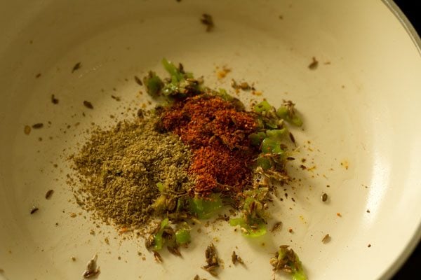 red chili powder and coriander powder added to pan. 