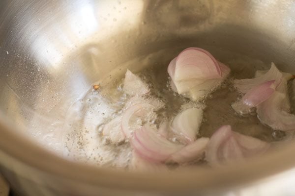 sliced onions in oil to make coconut curry.