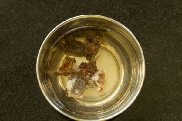 tamarind soaking in water in a steel bowl 