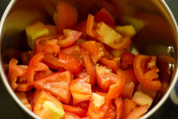 chopped tomatoes added to a blender 