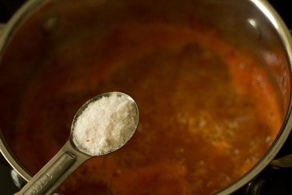 salt being added with a measuring spoon