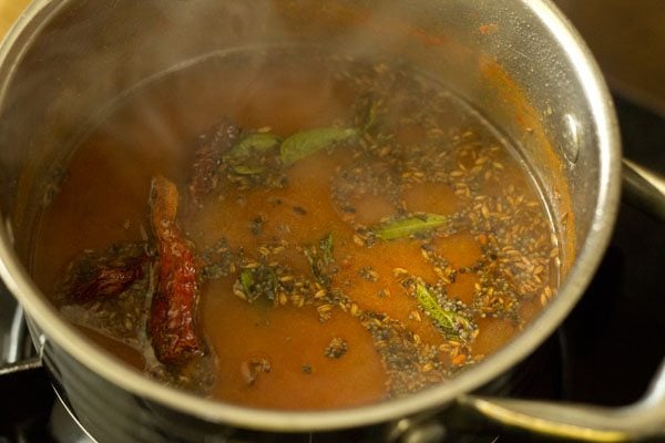 fried tempering ingredients added to tomato charu