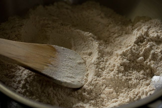 roasting whole wheat flour in the pan for atta ke laddu. 