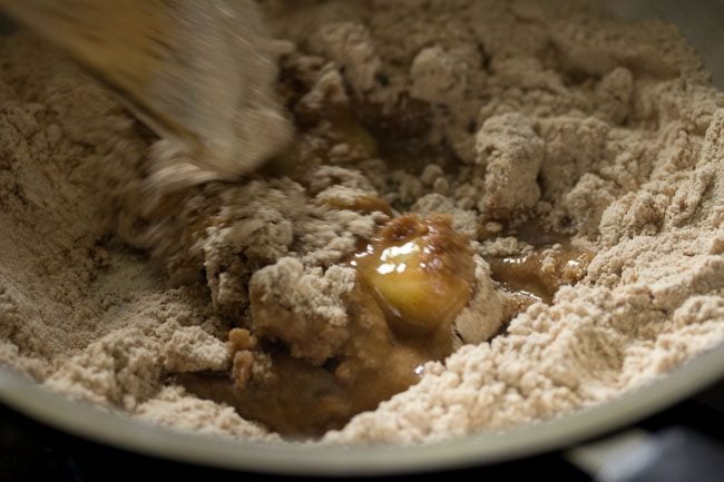 mixing the ghee with the roasted flour. 