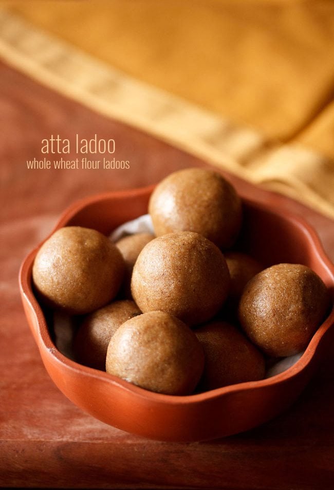 atta ladoo served in a brown bowl with text layovers.