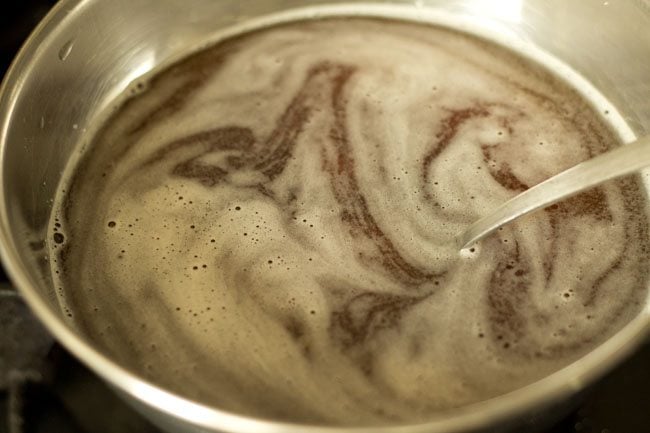 stirring and heating the solution so that the jaggery melts. 