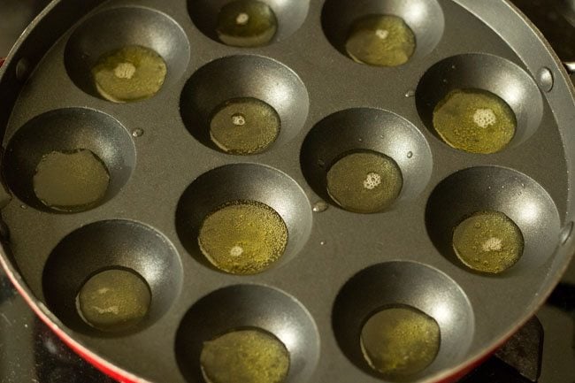 heating ghee in each mould of appe pan. 