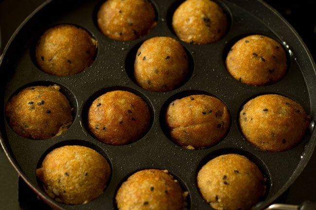 cooking sweet appam till golden and crisp. 