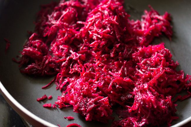 grated beetroot added to pan