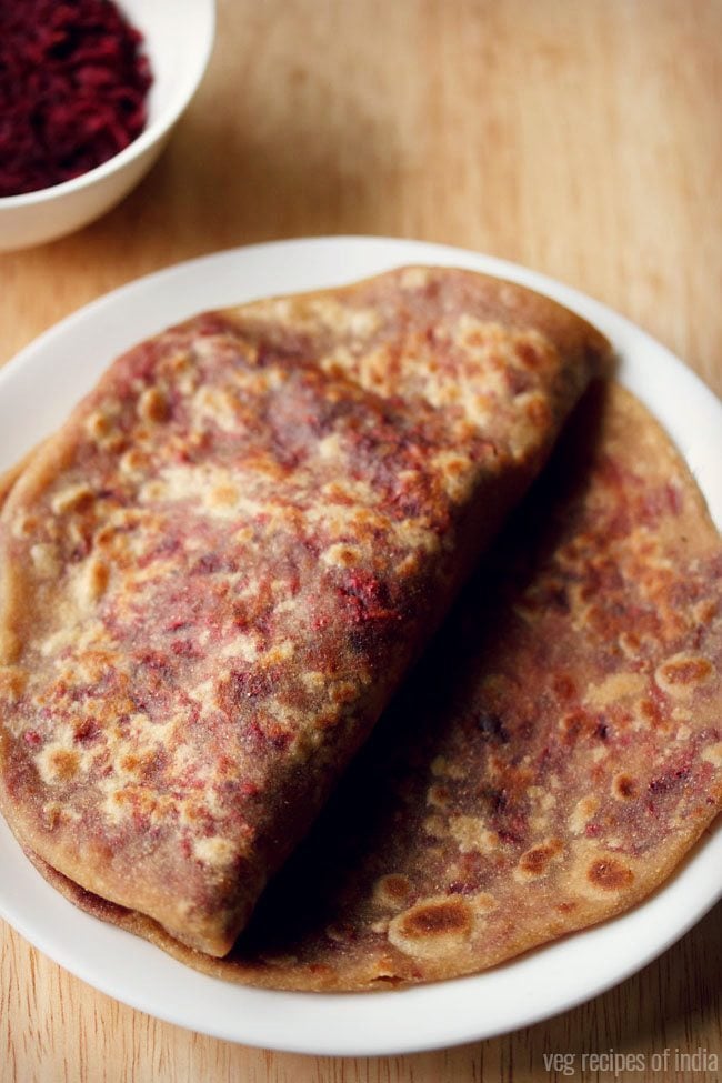 beetroot paratha served on a white plate